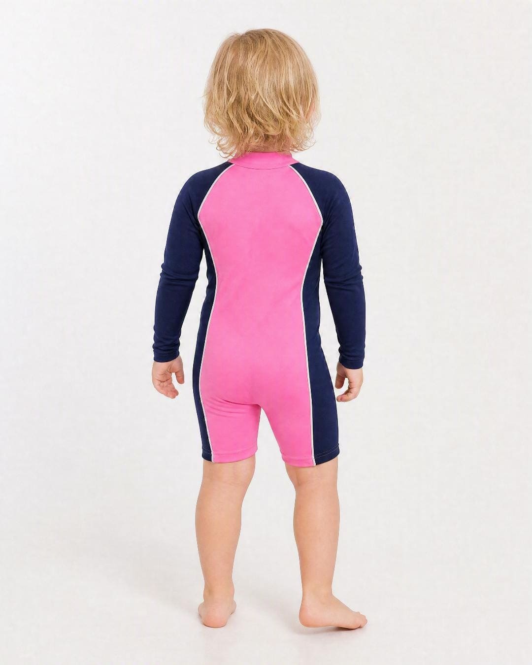 Back of 2 year old wearing a long sleeve UV swimsuit UPF 50+ - navy pink