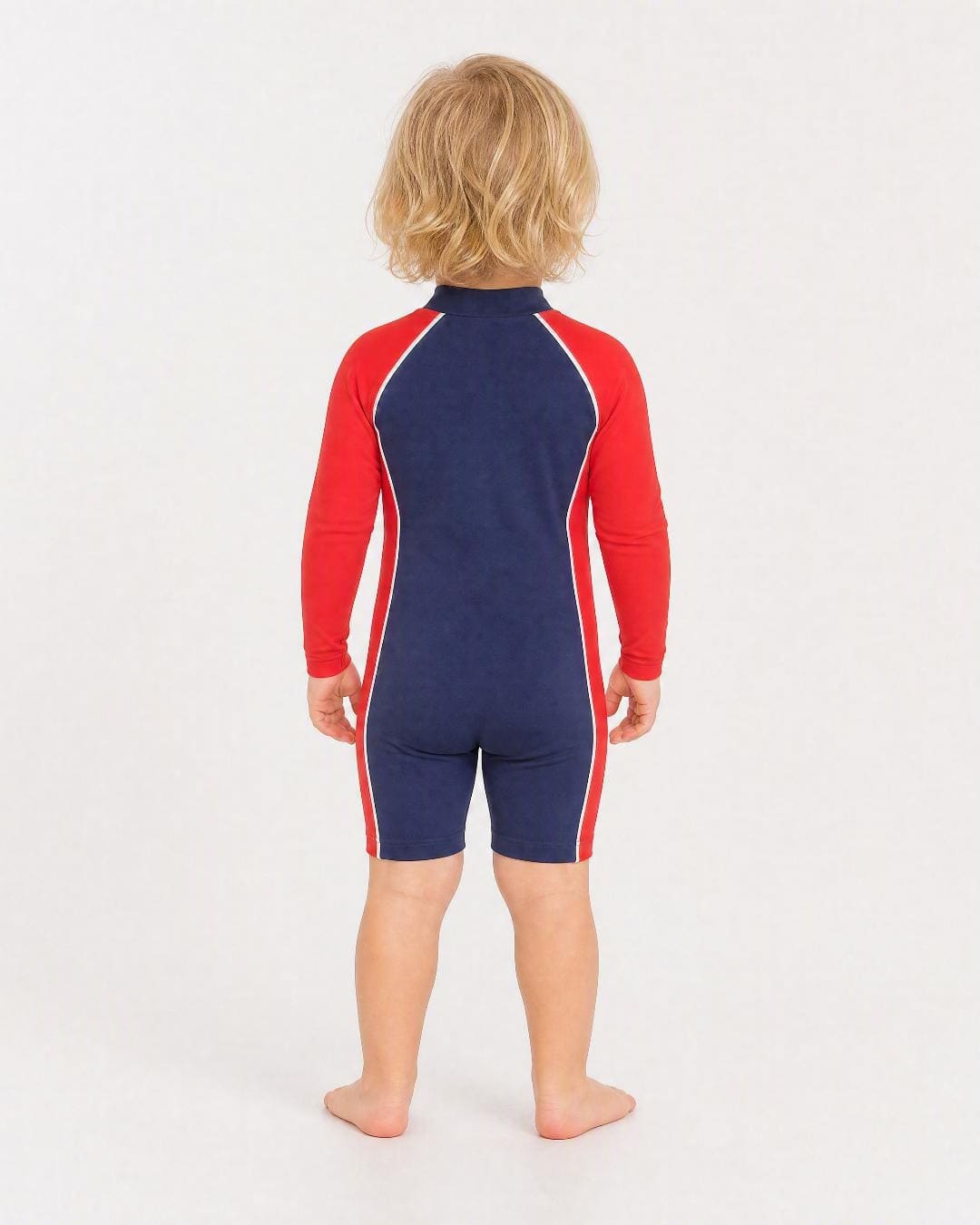 Back of 2 year old wearing a long sleeve UV swimsuit UPF 50+ - navy red