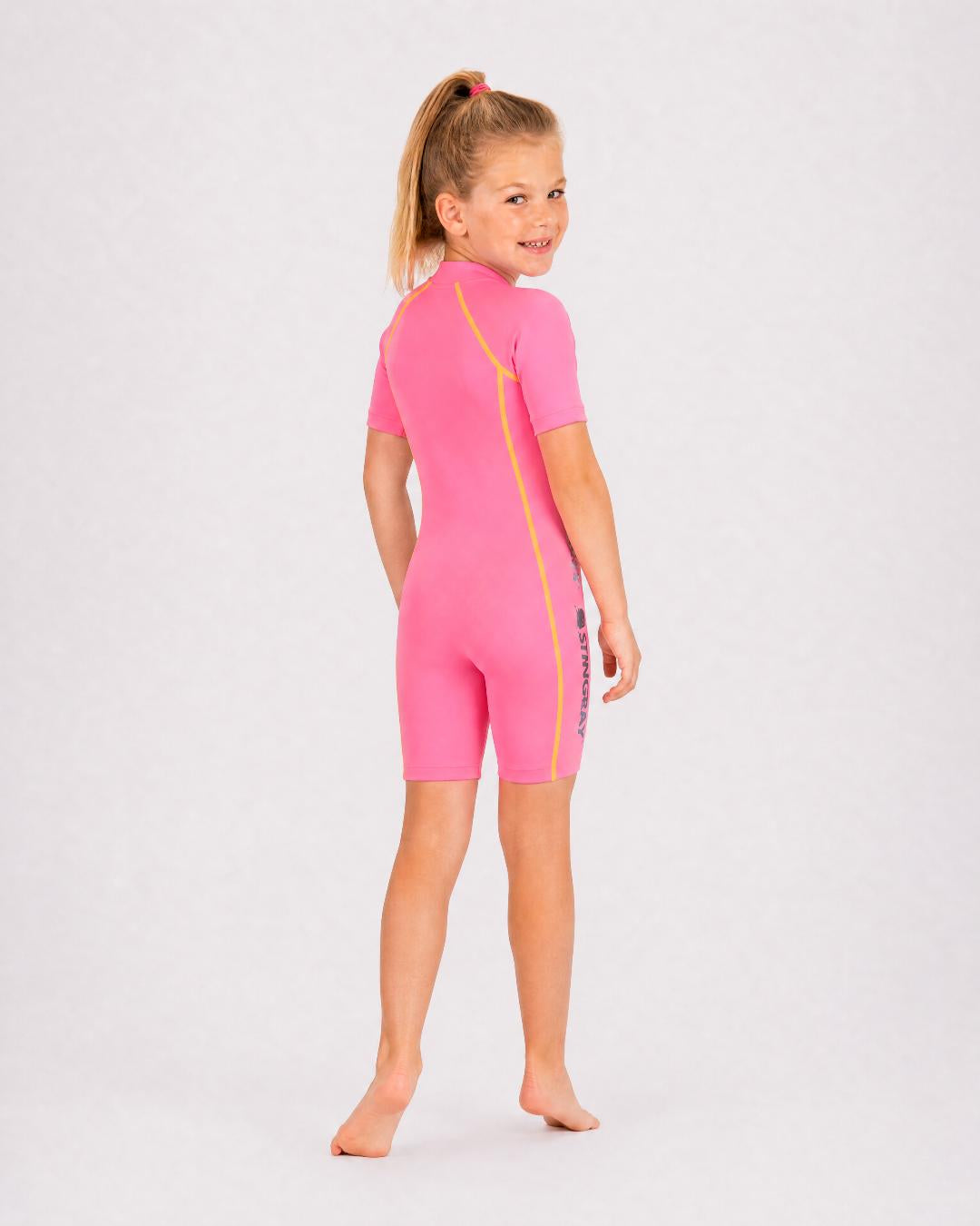 Back of 6 year old girl wearing short sleeve UV swimsuit UPF 50+ - pink