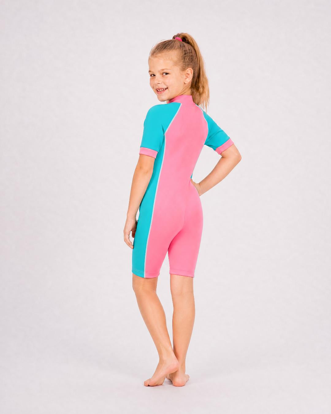 Back of 6 year old girl wearing short sleeve UV swimsuit UPF 50+ - pink teal
