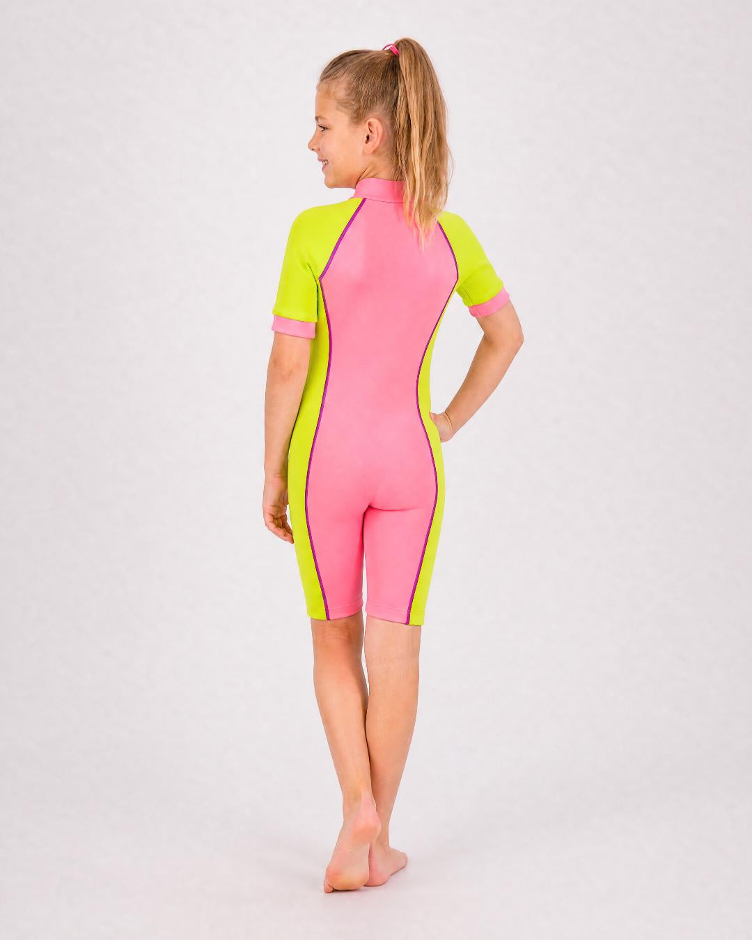 Back of 6 year old girl wearing short sleeve UV swimsuit UPF 50+ - pink yellow