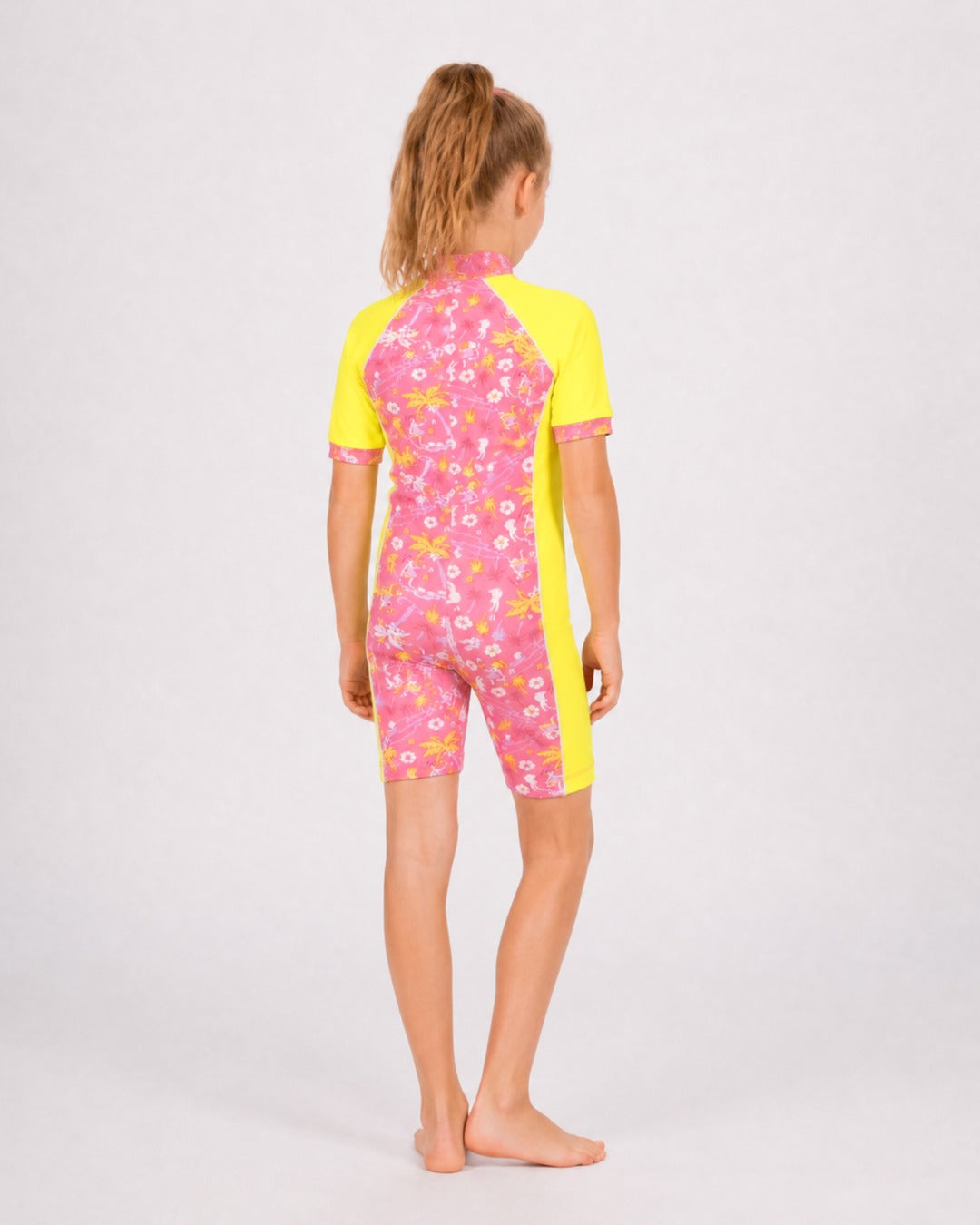 Back of 6 year old girl wearing short sleeve UV swimsuit UPF 50+ - yellow floral