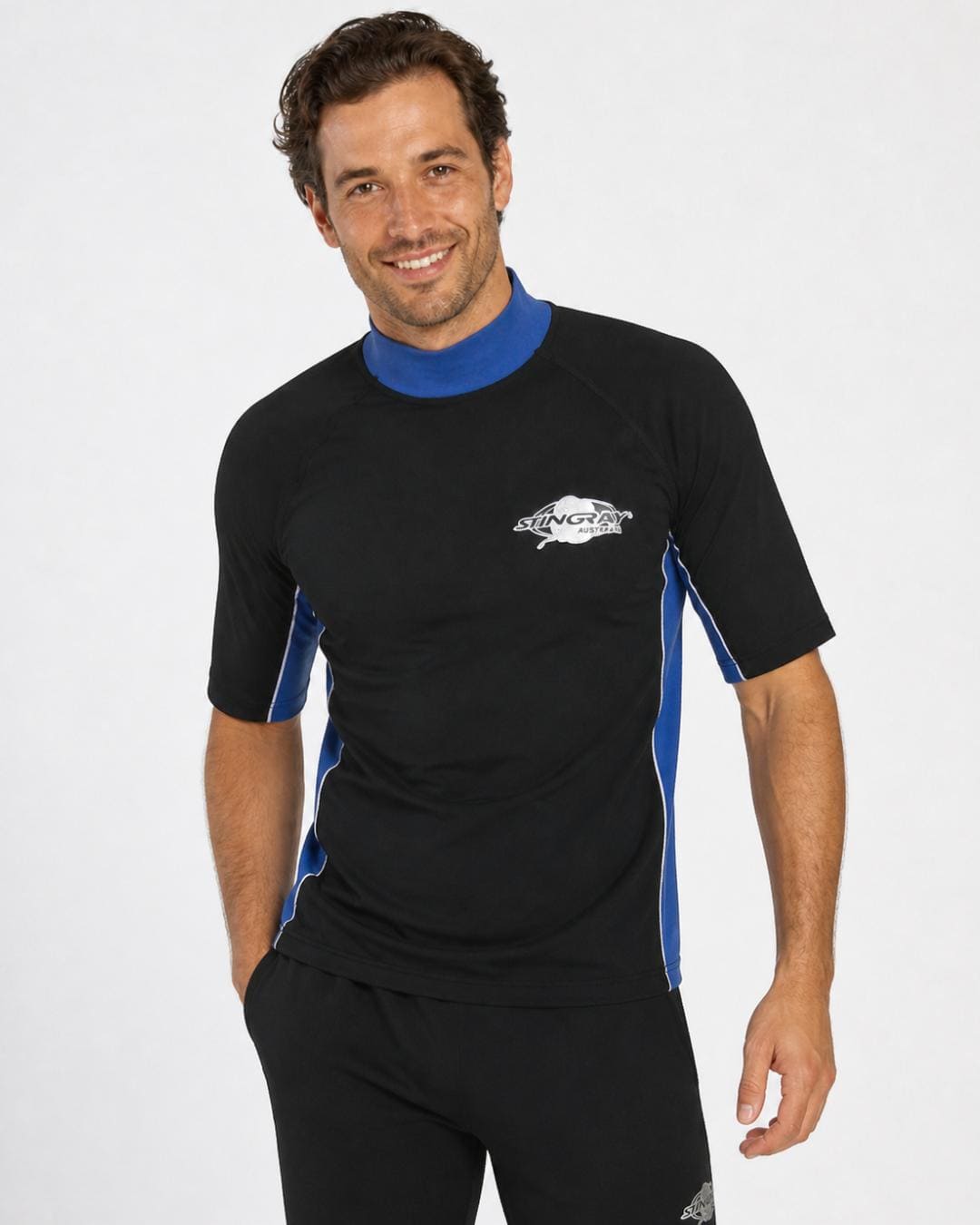 Man wearing black and ocean blue UV rash shirt UPF 50+ in a white studio