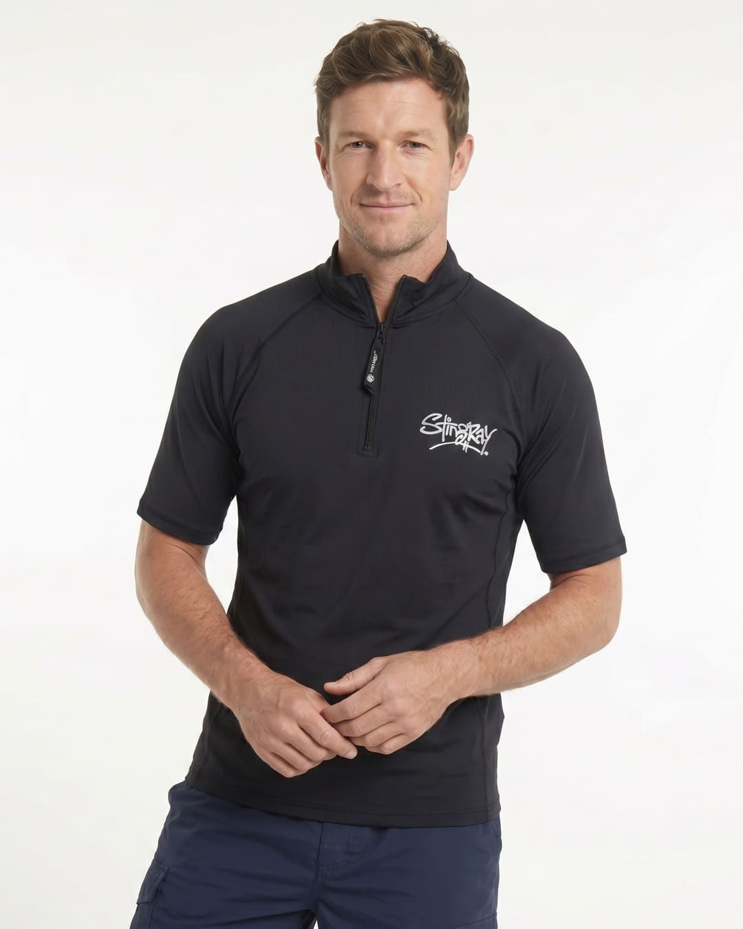 Man wearing a black short-sleeve UV zipped rash shirt on a white background