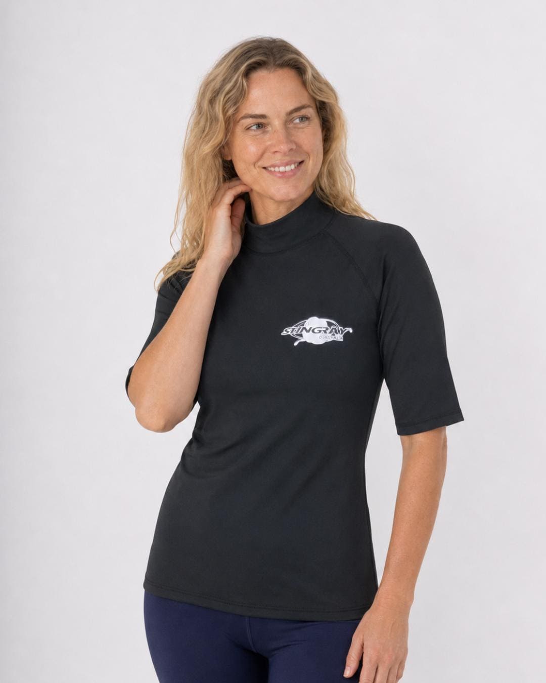 Woman wearing an black UV swim shirt UPF 50+ on a white background