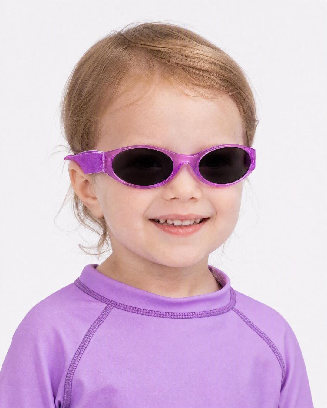 Child wearing kids banz sunglasses in purple in studio