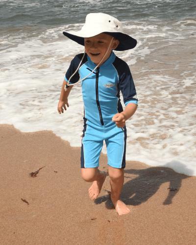 Child wearing an azure and navy blue UPF 50+ sun protection swimwear