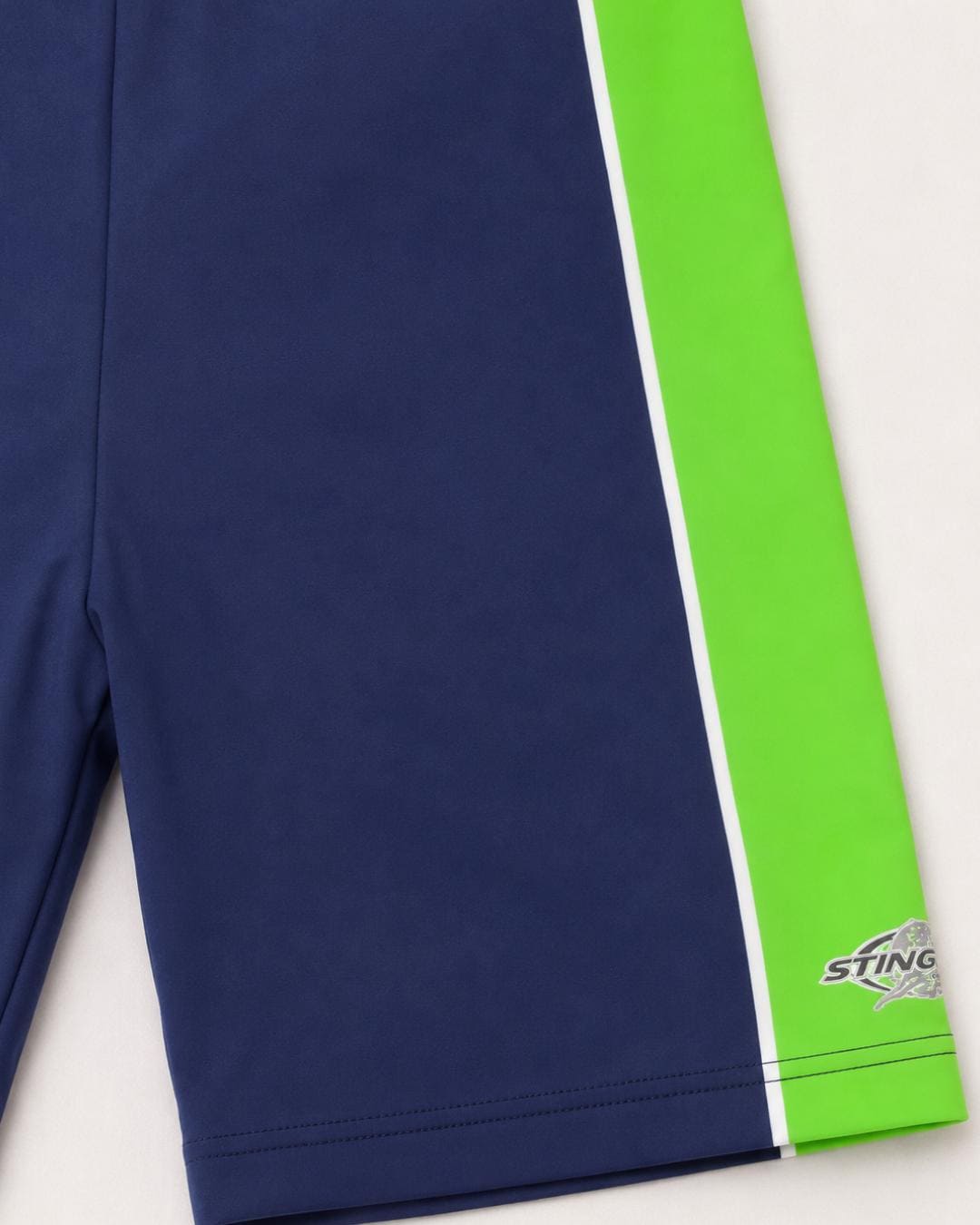 Flat lay of navy and green UV swim shorts for kids UPF 50+