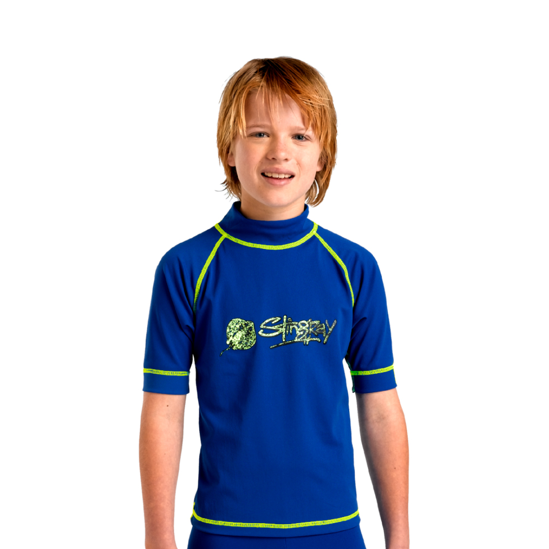 Toddler boy wearing the royal blue Stingray Kids' Unisex Surf Rash Top UPF 50+, showcasing its soft, durable fabric. This swim shirt provides the best UV sun protection for outdoor and water activities.