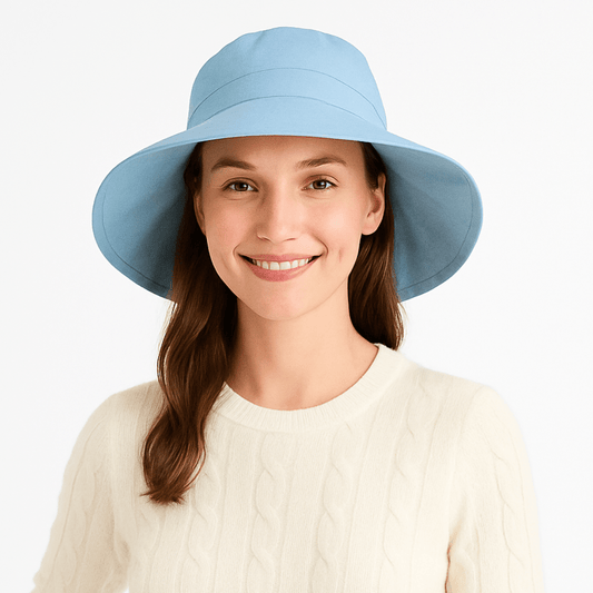 Model wearing light blue Stingray Women's Sun Hat with 4-inch wide brim and UPF 50+ sun protection. Fully-lined 100% cotton wide-brimmed sun hat with adjustable interior drawstring.
