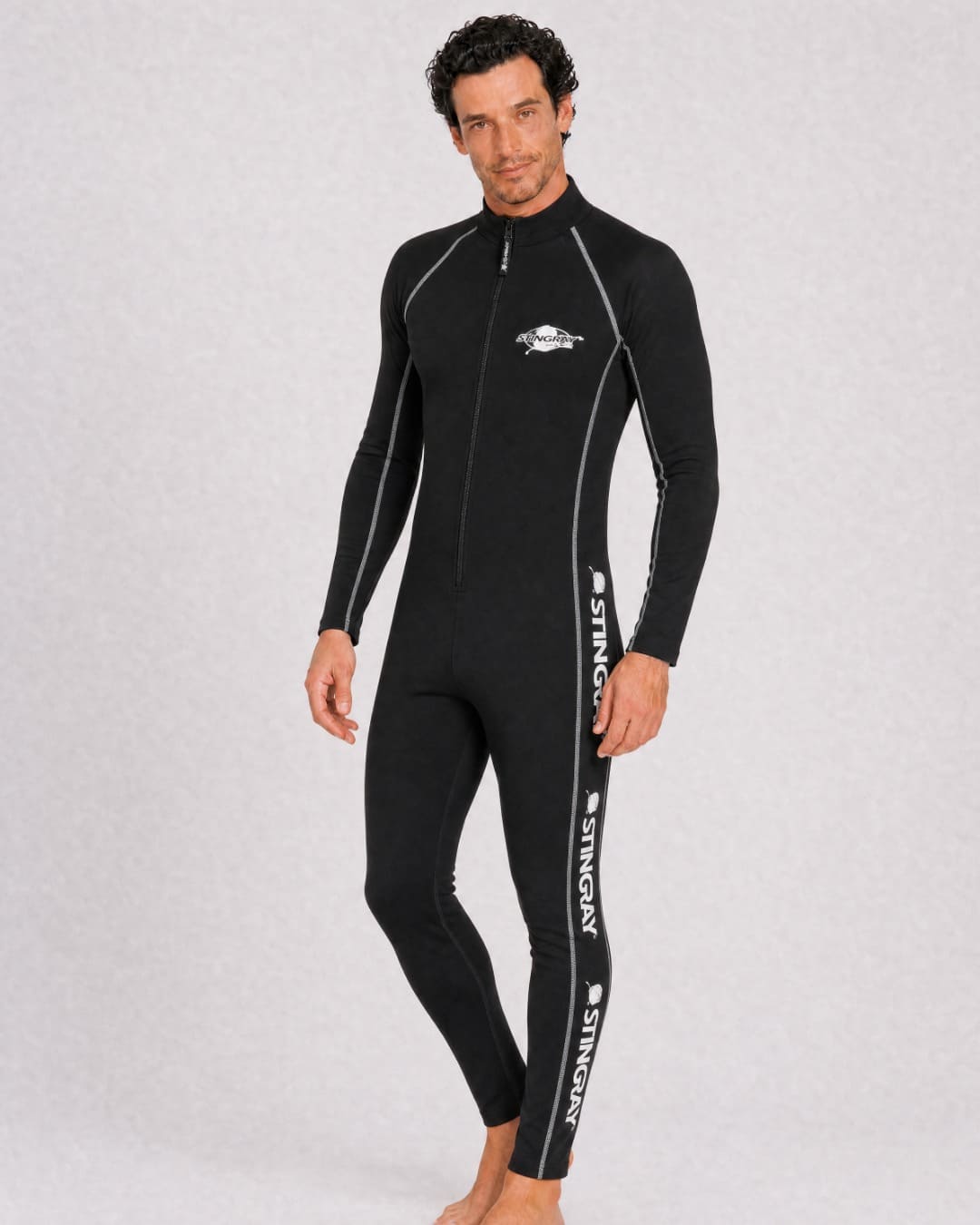 Man wearing a black full body UV swimsuit UPF 50+ in a white studio