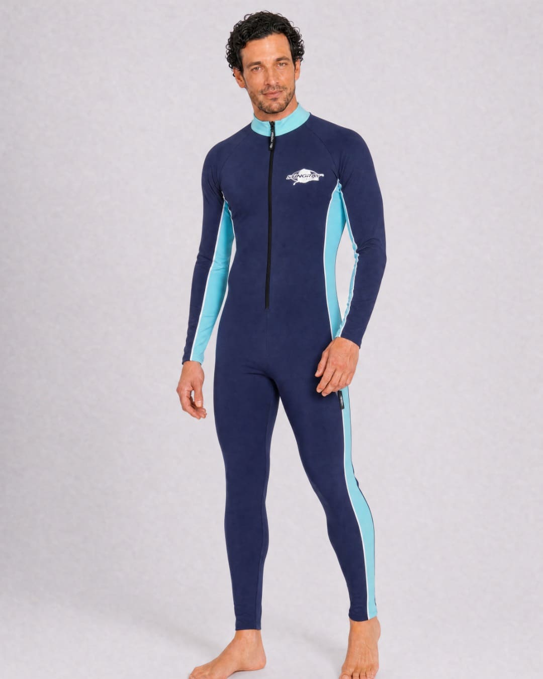 Man wearing a navy and aqua full body UV swimsuit UPF 50+ in a white studio