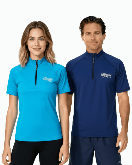 Woman wearing blue and man wearing navy Stingray unisex adult short sleeve quarter zip rash shirt with UPF 50+ sun protection.