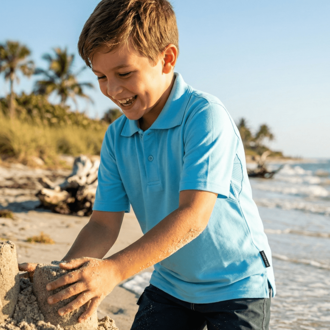 Child wearing upf 50+ short sleeve polo shirt on the beach