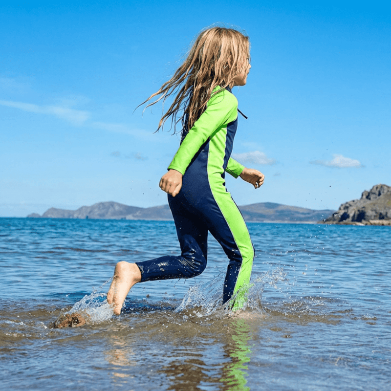 Child in a green full body UPF swimsuit