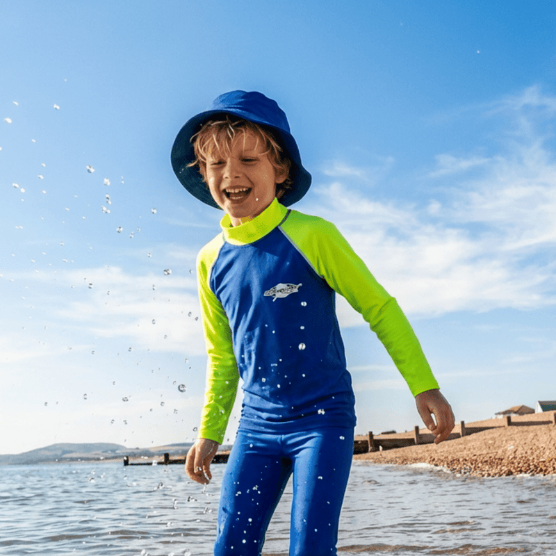 Child wearing uv sun hat on the beach