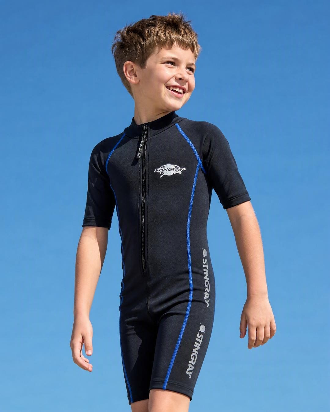Lifestyle of 14 year old boy wearing short sleeve UV swimsuit UPF 50+ - black
