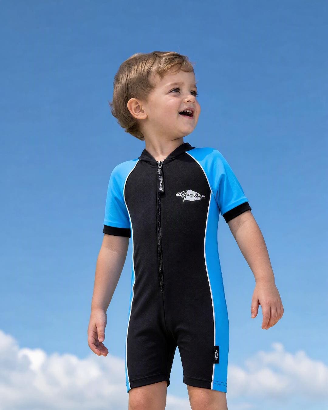 Lifestyle of 2 year old toddler wearing short sleeve UV sunsuit - black azure