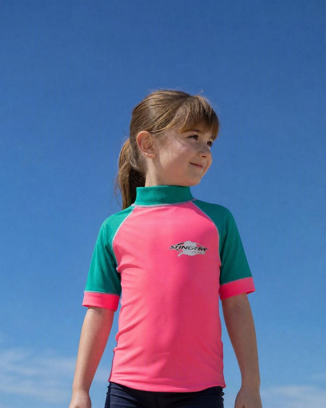 Lifestyle of 4 year old girl wearing short sleeve uv rash vest UPF 50+ - pink topaz