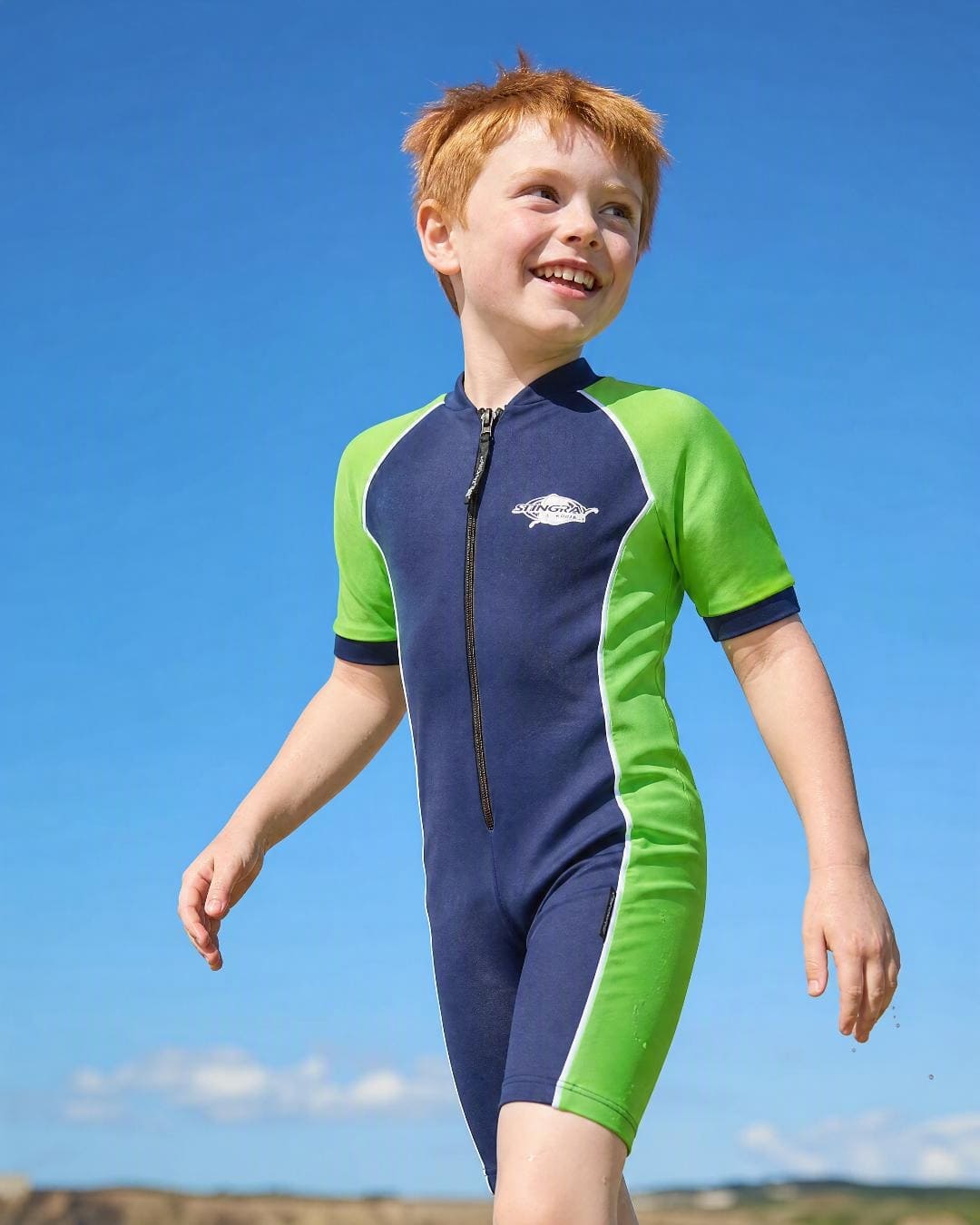 Boy swimming in a kids' short sleeve UV swimsuit UPF 50+ in navy and green