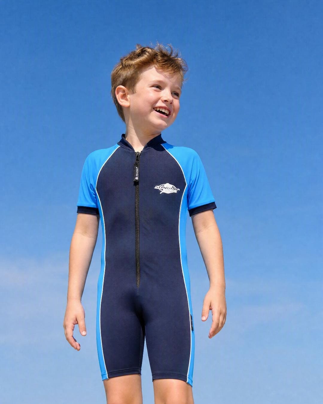 Lifestyle of 8 year old girl wearing short sleeve UV swimsuit UPF 50+ - navy azure