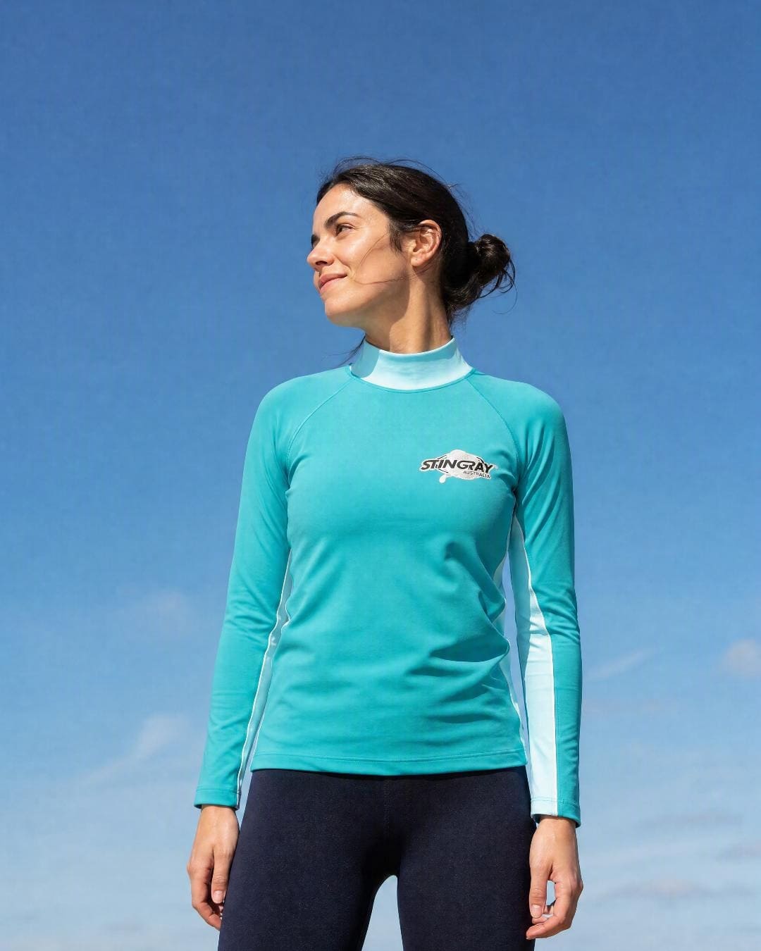 Lifestyle of Woman Wearing Long Sleeve UV Rash Shirt UPF 50+ in Aqua Teal