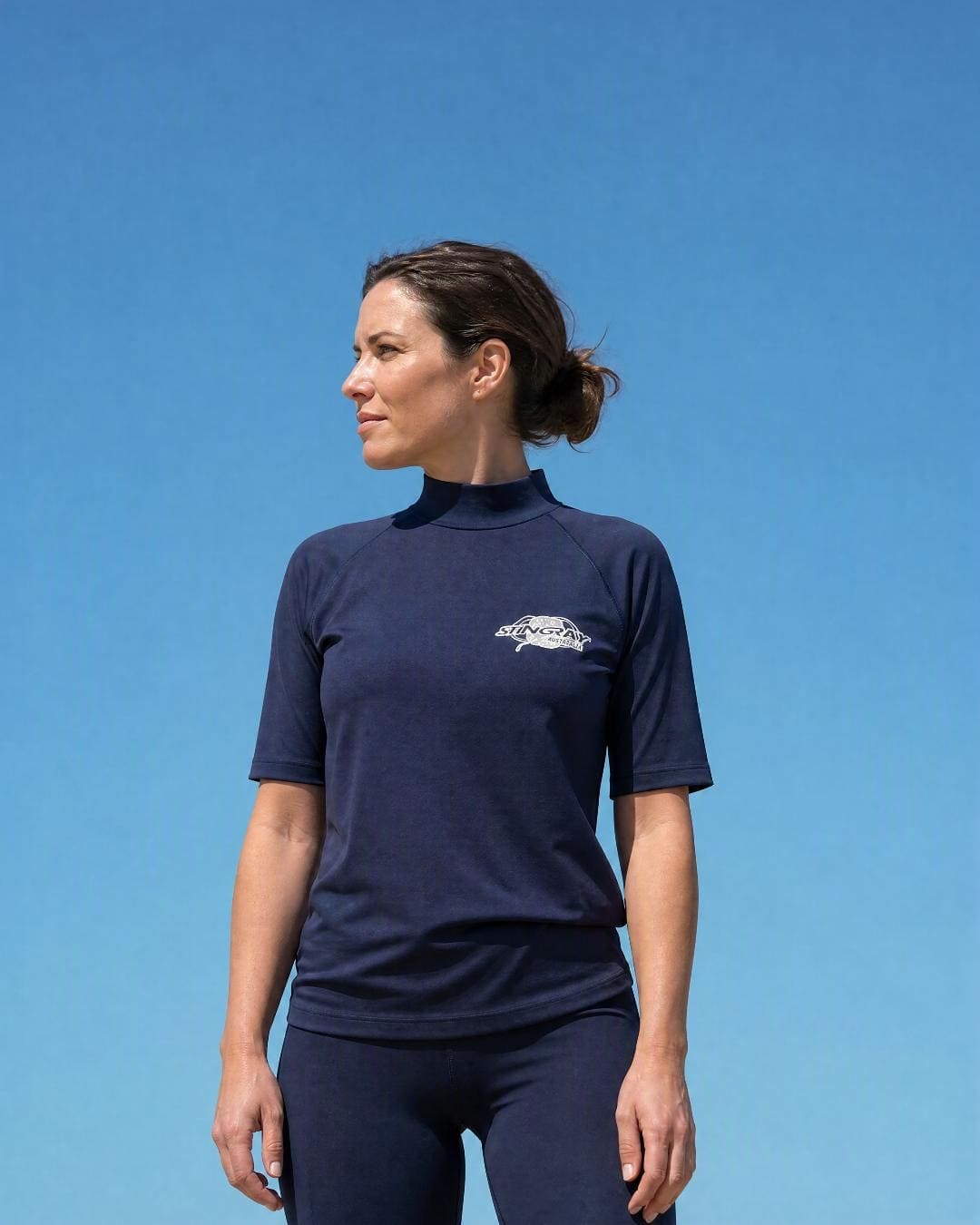 Lifestyle of Woman Wearing Short Sleeve UV Rash Shirt UPF 50+ in Navy