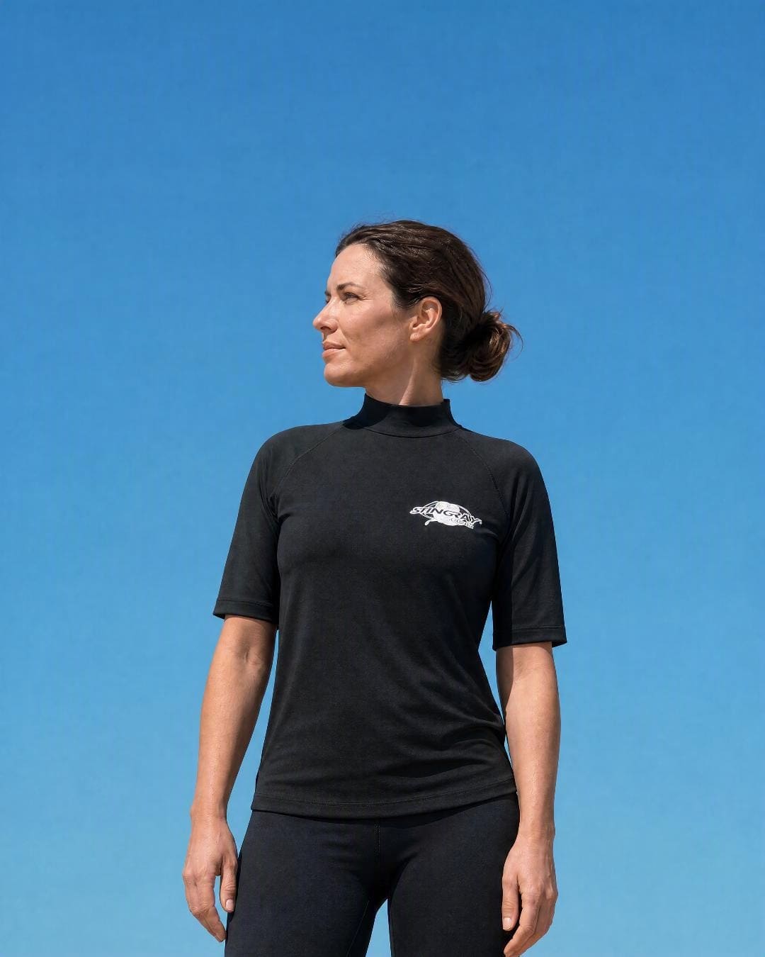 Lifestyle of Woman Wearing Short Sleeve UV Swim Shirt UPF 50+ in Black