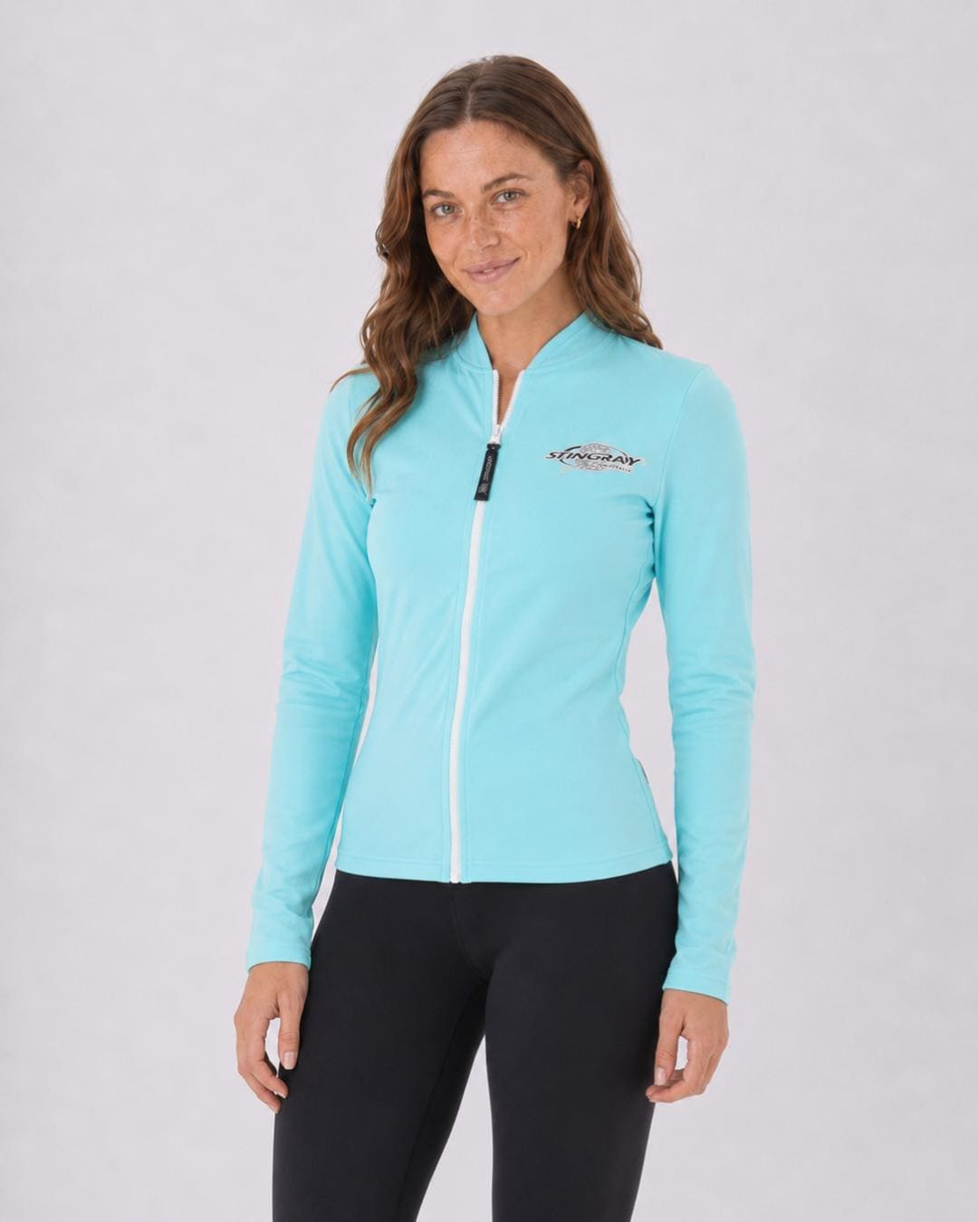 Woman wearing a aqua blue UV jacket UPF 50+ on a white background
