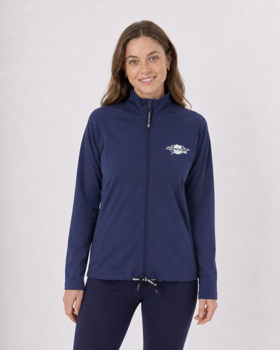 Woman wearing a navy long sleeve UV jacket UPF 50+ on a white background