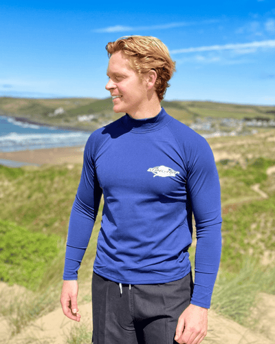 Man wearing sun protection clothing and swimwear