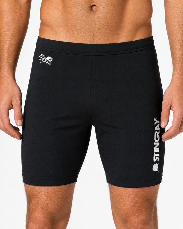 Man wearing black UV swim shorts UPF 50+ in a white studio