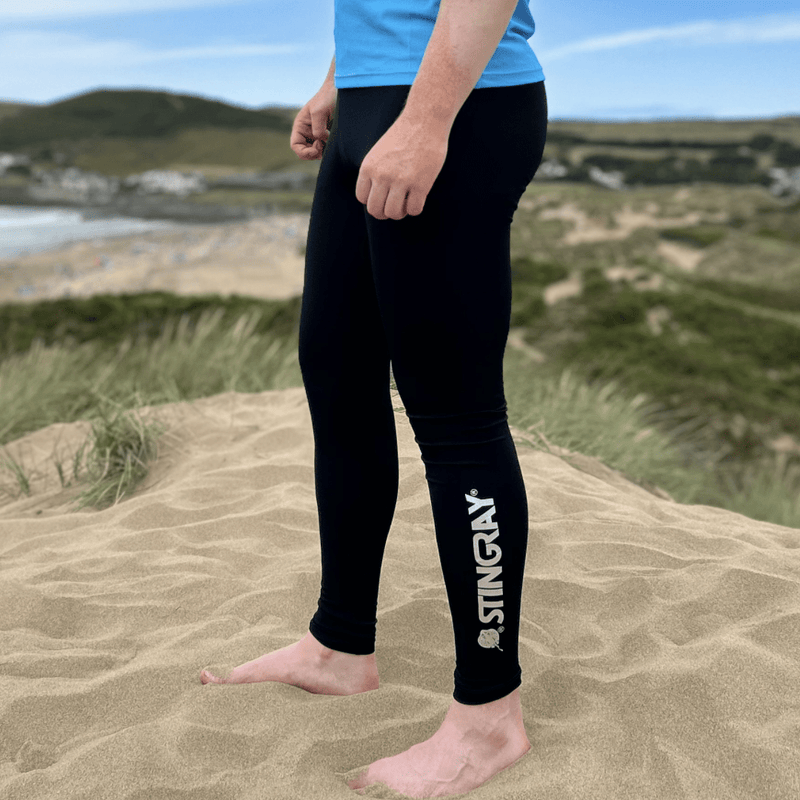 Man wearing uv bottoms standing on the beach