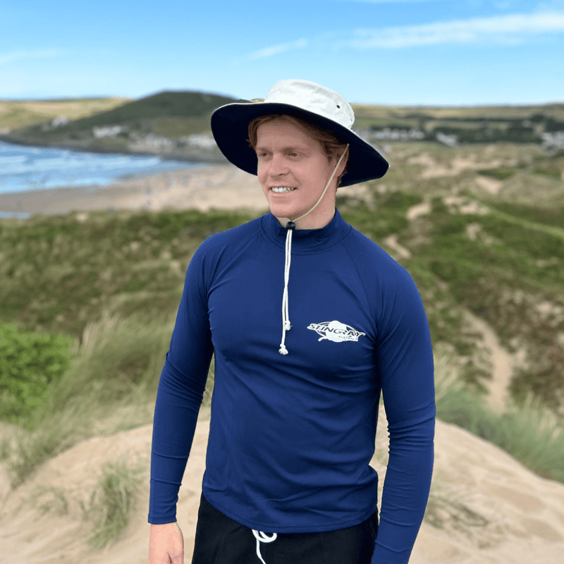 Man wearing uv cricket hat standing on the beach