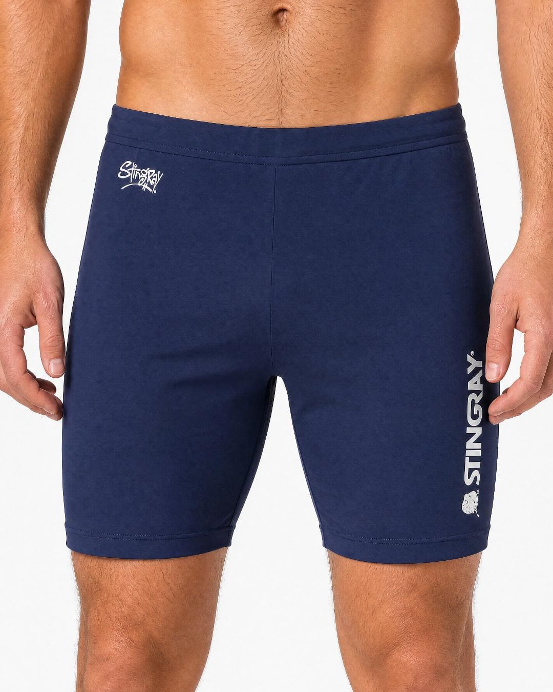 Man wearing navy UV swim shorts UPF 50+ in a white studio