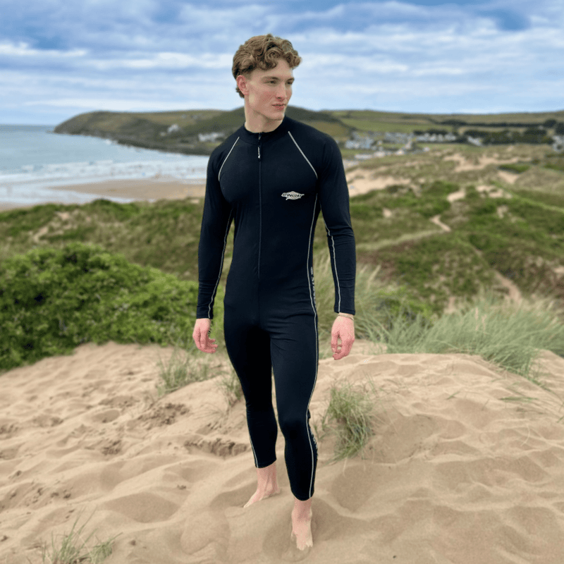 Man wearing UPF swimwear n the beach