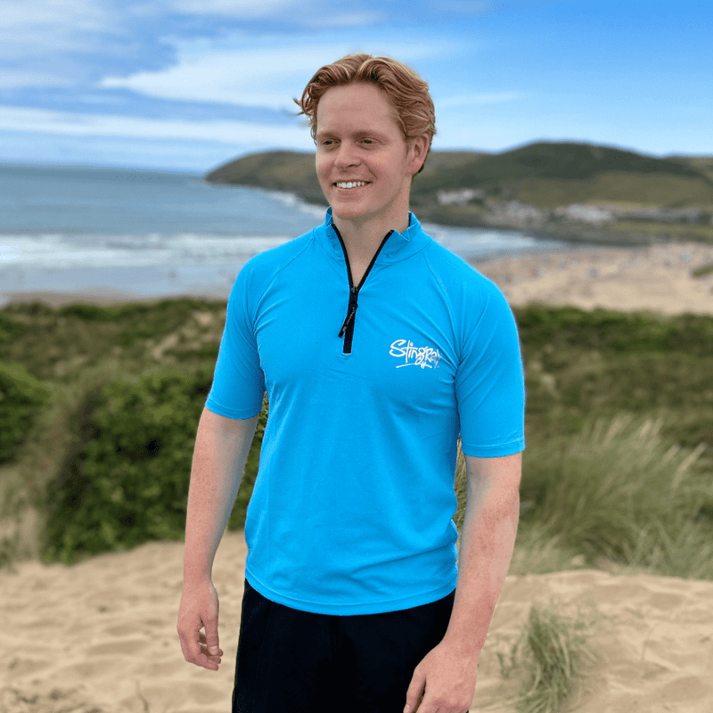 Man wearing UV top on the beach