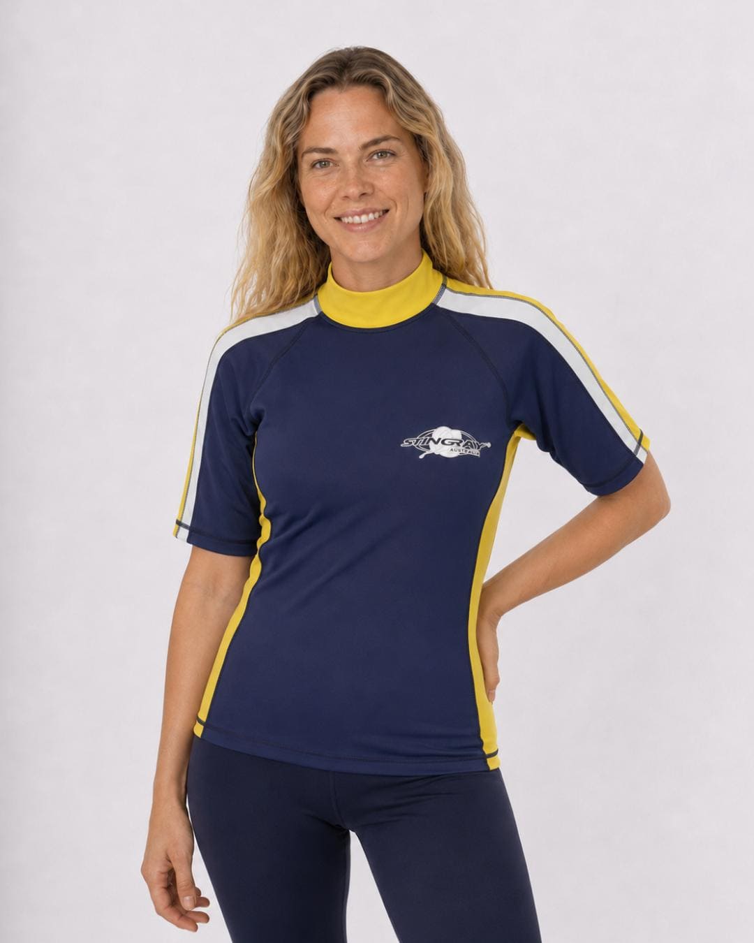 Woman wearing a navy and yellow with a white stripe UV swim shirt UPF 50+ on a white background