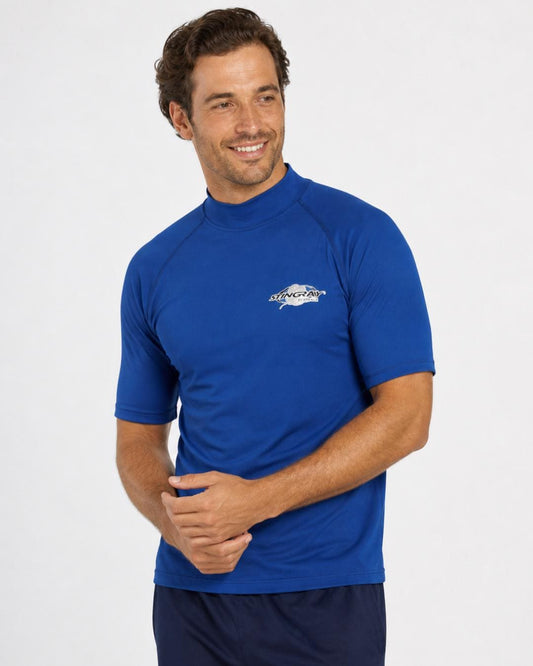 Man wearing ocean blue UV rash shirt UPF 50+ in a white studio