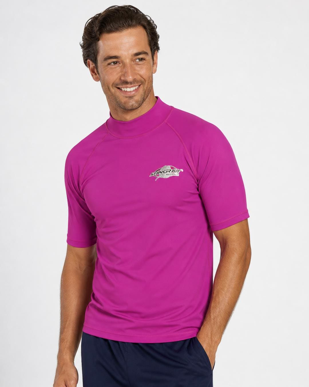 Man wearing purple UV rash guard UPF 50+ in a white studio