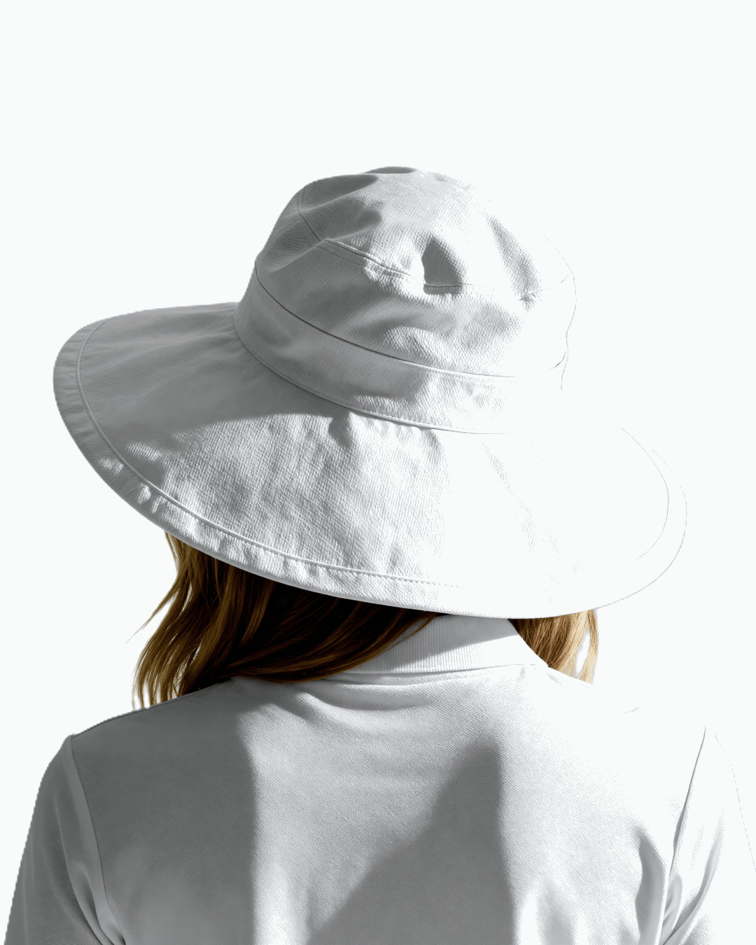 Behind angle of a woman wearing a white Stingray Sun Hat with 4-inch wide brim and UPF 50+ sun protection. 
