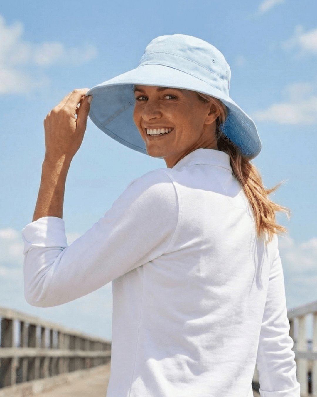 Woman wearing blue UV wide brim sun hat
