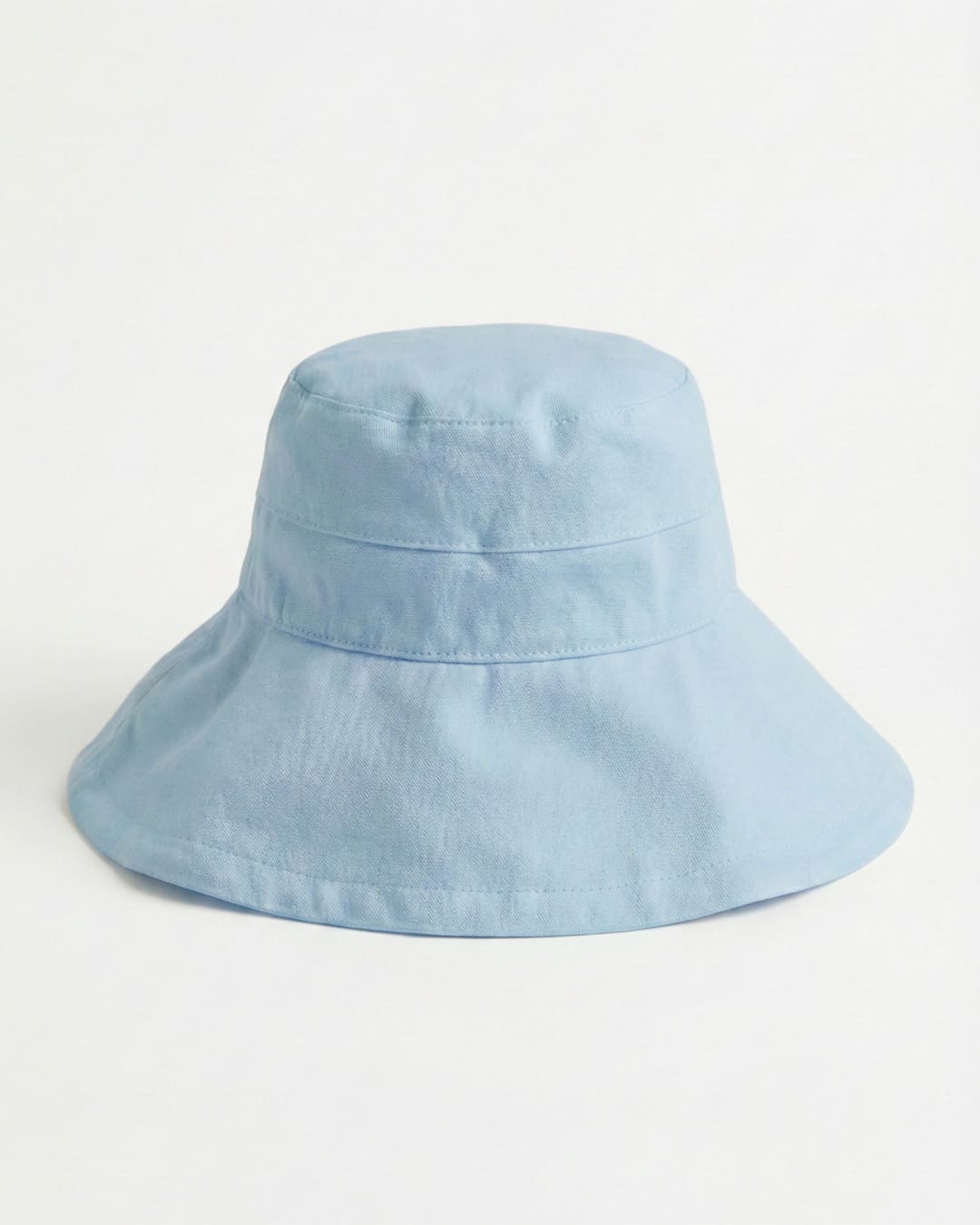 Wide brim light blue UPF 50+ sun hat in a grey studio setting