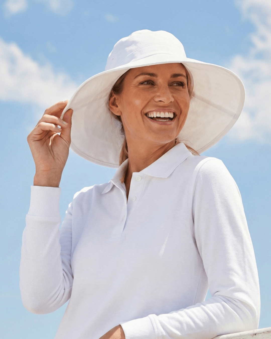 Woman wearing white UV wide brim sun hat