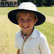 Review pic: boy wearing uv cricket hat on a cricket field
