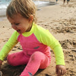 Review pic: child playing in the sand wearing a UPF 50+ rash vest