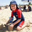 Review pic: child wearing UV swim shorts sitting on the beach