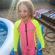 Review pic: girl wearing long sleeve UV swimsuit in her garden