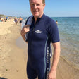Review pic: man wearing UPF 50+ short sleeve sunsuit on the beach