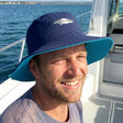 Review pic: man wearing UV bucket hat whilst on a boat